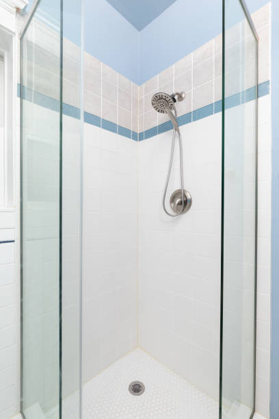 istock A A blue bathroom with a tiled walk-in shower. 1478509147