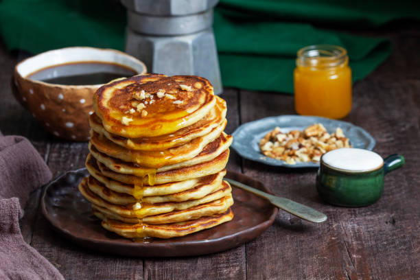 istock Apple pancakes served with honey, sour cream, nuts, tea and coffee. 1478511190