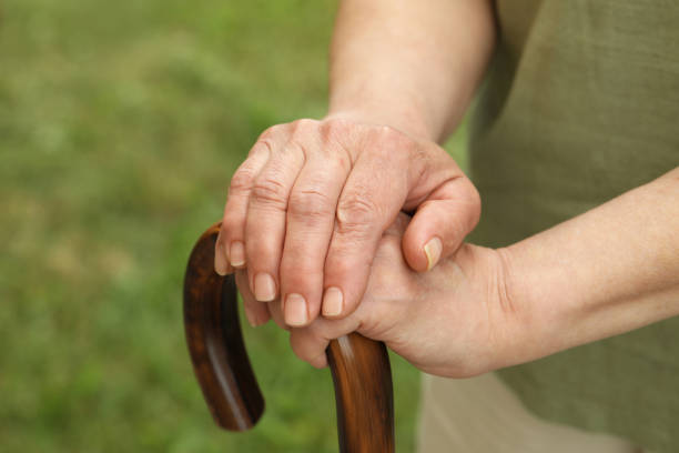 istock Elderly woman with walking cane outdoors, closeup 1478512597