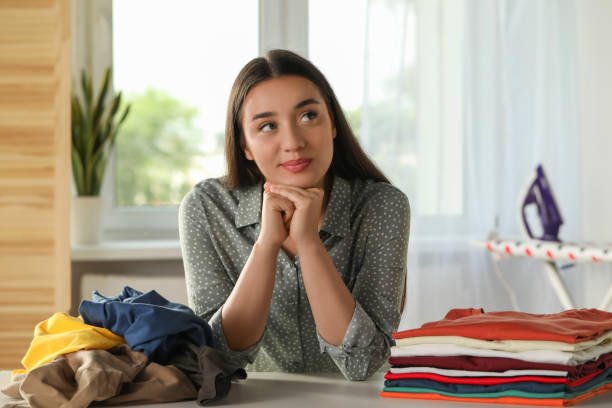 istock Young woman at table with different clothes indoors 1478512711