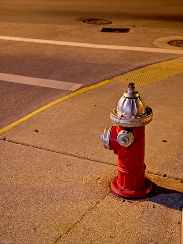 Fire hydrant illuminated by streetlights in downtown Saint Augustine Florida.