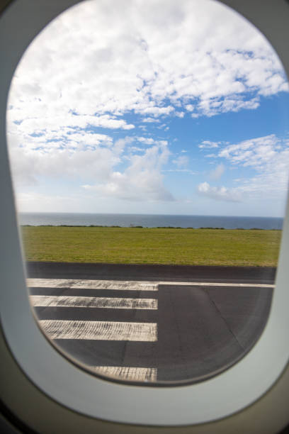 istock Photo from the plane window, ocean and sky, runway view. 1478527065