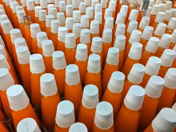 istock Orange glass bottles for parties with white lids. 1478531735