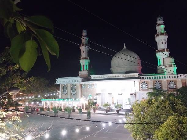 istock Illuminated Mosque Courtyard with Green Tower Lights at Night 1478531786
