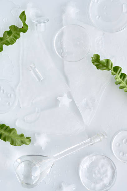 istock Crushed ice, glassware, petri dishes with moisturizer and oil drops, face care routine mockup, background with space for your product. 1478533902