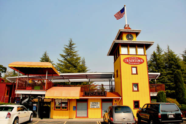 Sonoma, California, USA - July 24, 2008: An American flag waves in the wind atop the entrance to the historic “Sonoma Traintown Railroad” amusement park.