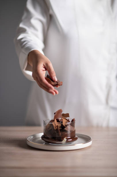 istock Chef pouring chocolate sauce on profiteroles 1478544254