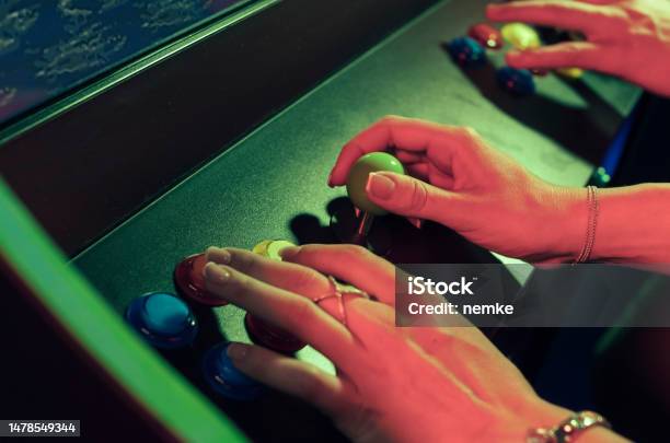 People Playing An Video Game Stock Photo - Download Image Now - Amusement Arcade, Arcade, Retro Style