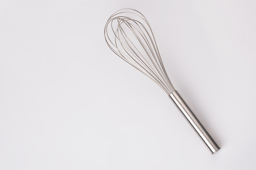 Stainless steel egg whisk on white background. cooking tool