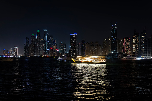 dubai marina night cruise. Luxury yachts in the night lights on the water.