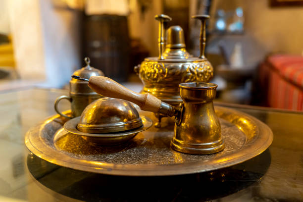 istock Making coffee according to an old Arabic recipe. metal copper objects for making coffee on table 1478557739