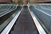 Modern luxury two escalators with staircase without people. moving staircase