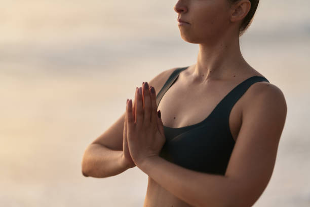 istock Crop woman meditating with clasped hands 1478559272