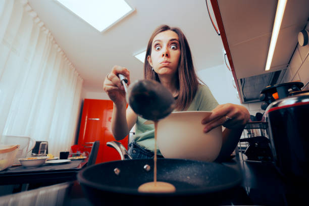 istock Woman Pouring Pancake Batter into the Pan 1478560167