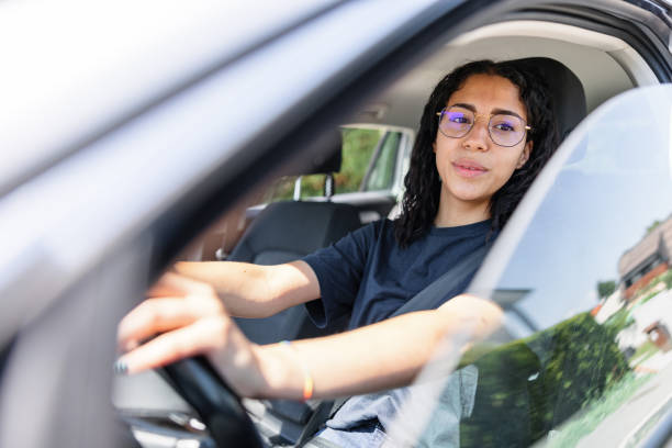 istock Young Adult Female Is Looking At Side Mirror While Driving 1478561263