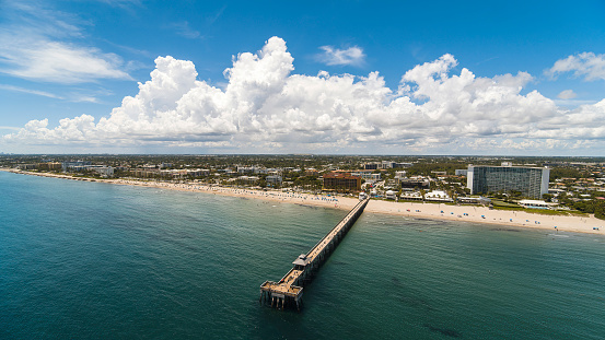Boardwalk for tourists from Deerfield Beach, Florida, on the shore of the Atlantic ocean, on a sunny day in summer.