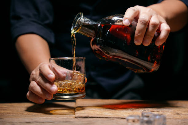 istock Barman pouring whiskey whiskey glass beautiful night 1478569512