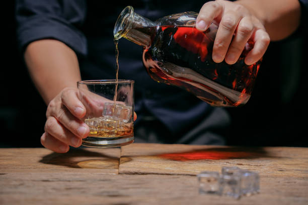 istock Barman pouring whiskey whiskey glass beautiful night 1478569526