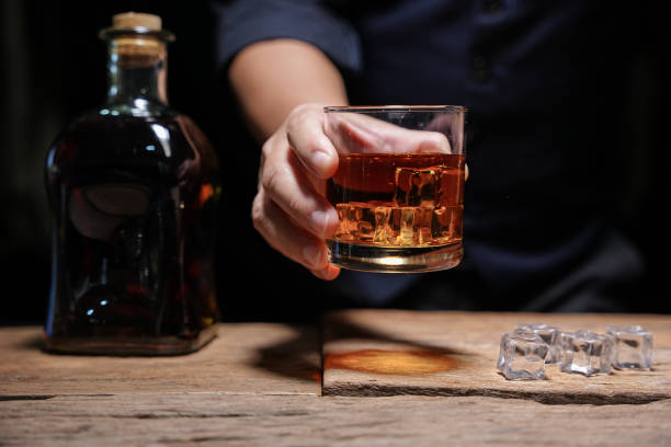 istock Barman pouring whiskey whiskey glass beautiful night 1478569535