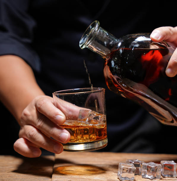 istock Barman pouring whiskey whiskey glass beautiful night 1478569548