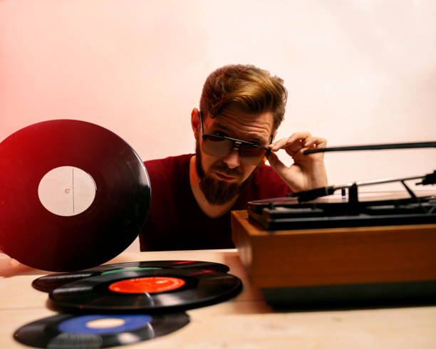 istock Bearded guy surrounded with vinyls next to turntable 1478571953