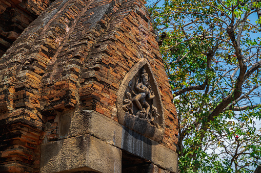 Close up of the intricate carved red sandstone walls of the Banteay Srei temple (or pink temple), Siem Reap, Cambodia