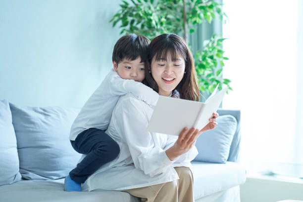 istock mother and boy sitting and reading picture book 1478591056