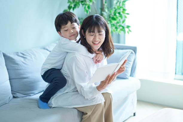 istock mother and boy sitting and reading picture book 1478591615