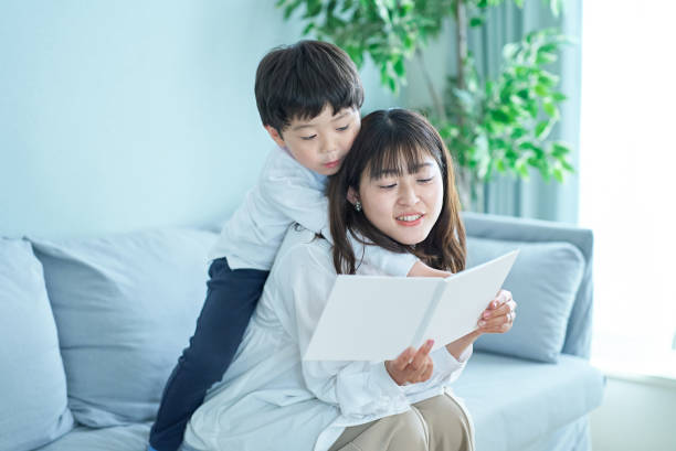 istock mother and boy sitting and reading picture book 1478592150