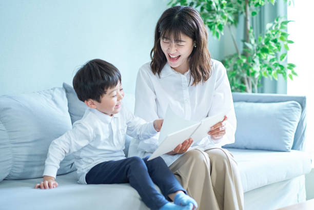 istock mother and boy sitting and reading picture book 1478593210