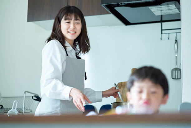 istock A child who draws and a mother who watches over while doing housework 1478600364