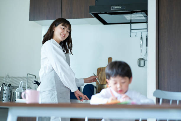 istock A child who draws and a mother who watches over while doing housework 1478600418