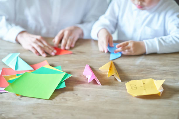 istock Parent and child playing with origami 1478602312