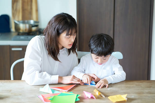 istock Parent and child playing with origami 1478602503