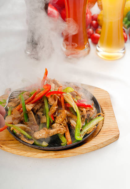 istock original fajita sizzling hot  on iron plate 147860257