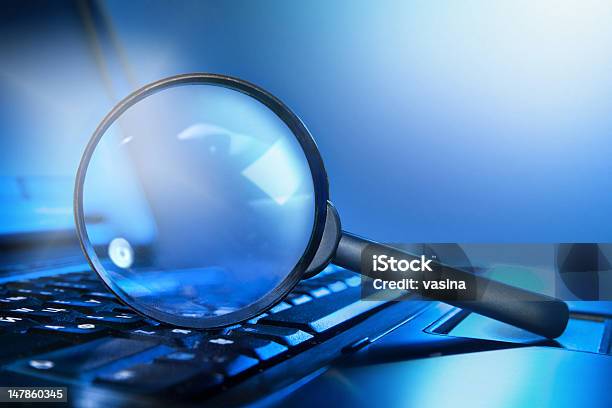 Magnifying Loupe On The Laptop Keyboard Stock Photo - Download Image Now - Magnifying Glass, Laptop, Research