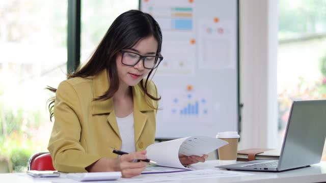 Businesswoman working with financial documents on desk in office, auditing, calculating income and expenses budget management plan.