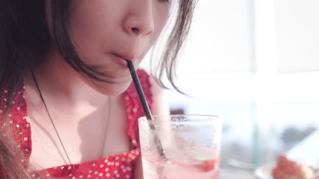 Beautiful teenage girl drinking fruit juice