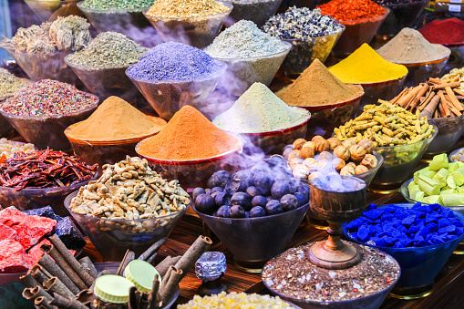 The colorful spice market with Arabic traditional incense bukhoor agar wood burner with the smoke, Dubai