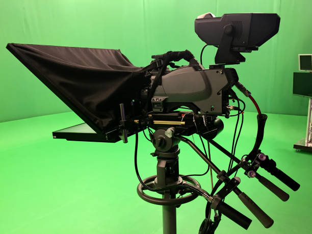 istock Modern empty green video recording and broadcasting studio with tv channel led screen and metalic stands, text prompter 1478638367