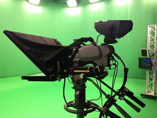 istock Modern empty green video recording and broadcasting studio with tv channel led screen and metalic stands, text prompter, lights on 1478638614