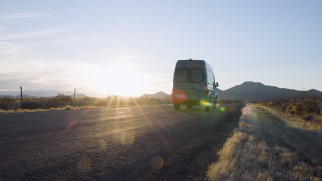 Road Trip in a Van Through the Desert Mountains During Sunset