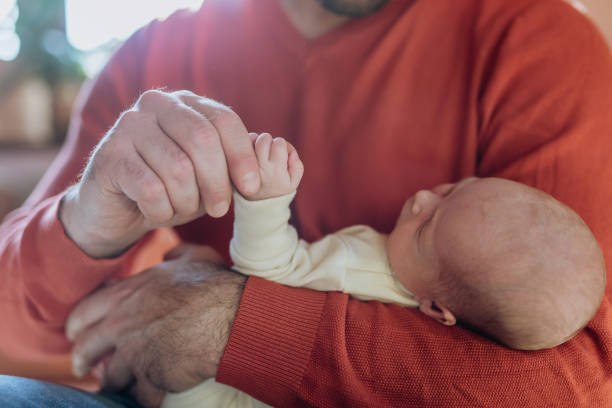 Close-up of father holding his little son. stock photo