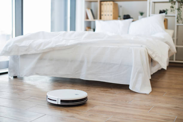 istock Wireless robot vacuum removing dust from floors during days 1478648189