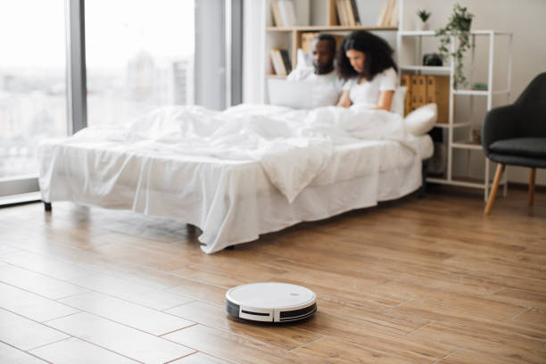 istock Robot vacuum cleaning floor in bedroom during daytime 1478649664