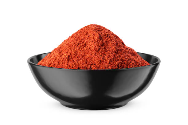 istock Ground red pepper in black bowl isolated on white. Front view. 1478651587