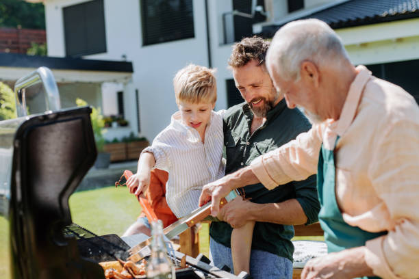 istock Multi generation family grilling outside on backyard in summer during garden party 1478653421