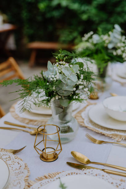 istock Festive wedding table setting with flowers at small reception in backyard in summer. 1478654343