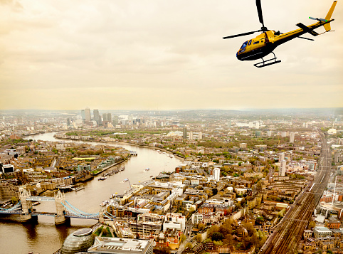 Helicopter Flying over Tower Bridge, London, UK.