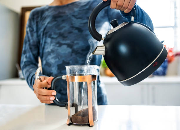 istock Unrecognizable person preparing coffee in kitchen 1478658667